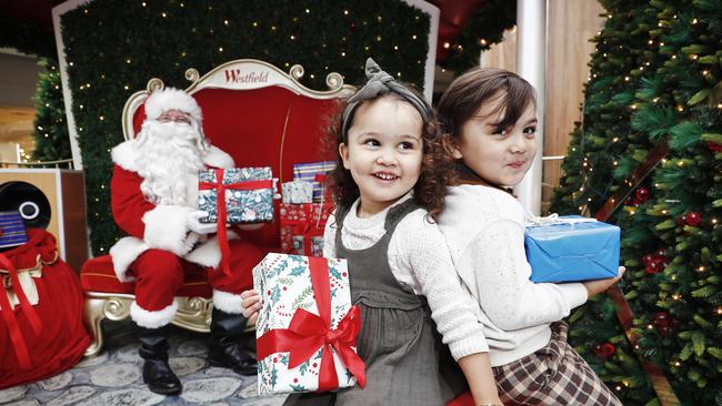 Santa visits Warringah Mall in Brookvale today and chats to kids while socially distanced. Siblings Elena and Louis Eaton pictured with Santa. Picture: Sam Ruttyn