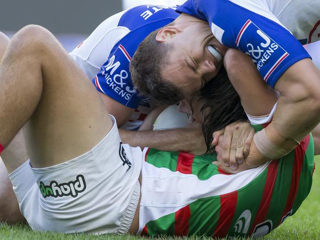 Corey Allan of the Rabbitohs is tackled during the Round 6 NRL match between the South Sydney Rabbitohs and the Canterbury Bulldogs at ANZ Stadium in Sydney, Friday, April 19, 2019. (AAP Image/Craig Golding) NO ARCHIVING, EDITORIAL USE ONLY