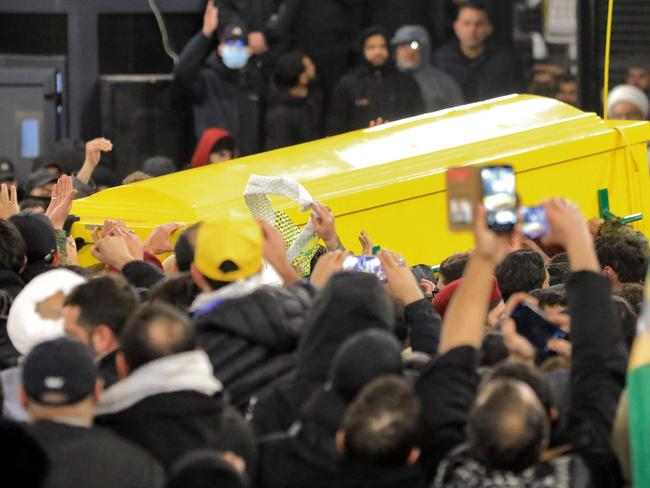 Mourners carry the coffin of Hezbollah's slain leader Hassan Nasrallah upon arrival at the burial place during his funeral in Beirut's southern suburbs on February 23, 2025. Tens of thousands of mourners dressed in black vowed support for Hezbollah at the Beirut funeral of slain leader Hassan Nasrallah, after the group was dealt major blows in its last round of hostilities with Israel. The September killing of the charismatic leader, who led Hezbollah for more than three decades, in a massive Israeli strike dealt a heavy blow to the Iran-backed group. (Photo by AFP)