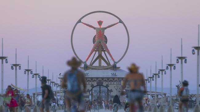 The Burning Man effigy, modelled after the Leonardo da Vinci's Vitruvian Man, stands above the playa during Burning Man at the Black Rock Desert north of Reno. Picture: AP