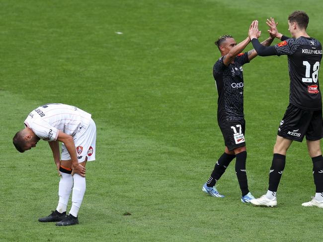 WELLINGTON, NEW ZEALAND - MARCH 31: Youstin Salas Gomez and Lukas Kelly-Heald of the Phoenix celebrate the win while Florin Berenguer of the Roar looks on in disappointment during the A-League Men round 22 match between Wellington Phoenix and Brisbane Roar at Sky Stadium, on March 31, 2024, in Wellington, New Zealand. (Photo by Hagen Hopkins/Getty Images)