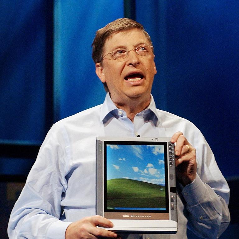 Bill Gates holds a tablet PC running a version of Windows XP. Picture: AFP/Stan Honda