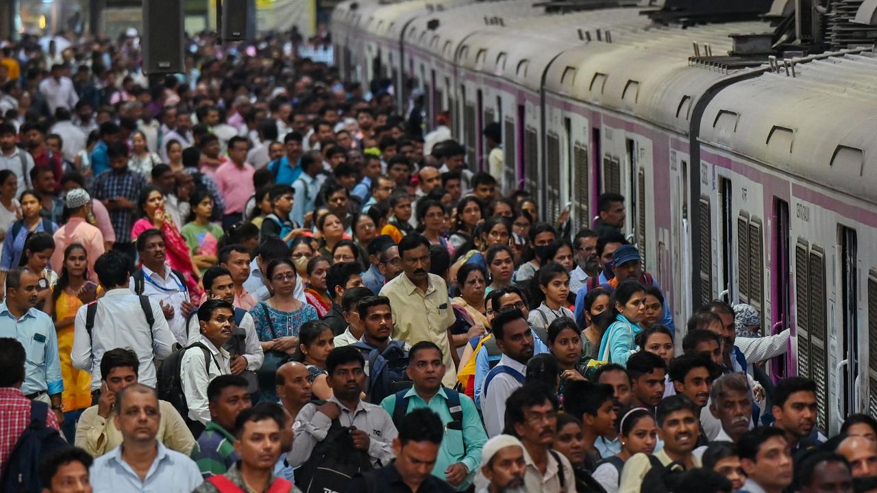 People crowd on platforms as they wait for their train in Mumbai. Picture: AFP