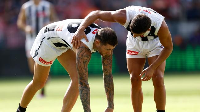 SYDNEY, AUSTRALIA - MARCH 09: Jeremy Howe of the Magpies (left) is helped to his feet by teammate Nick Daicos during the 2025 AFL Opening Round match between the GWS Giants and the Collingwood Magpies at ENGIE Stadium on March 9, 2025 in Sydney, Australia. (Photo by Michael Willson/AFL Photos via Getty Images)