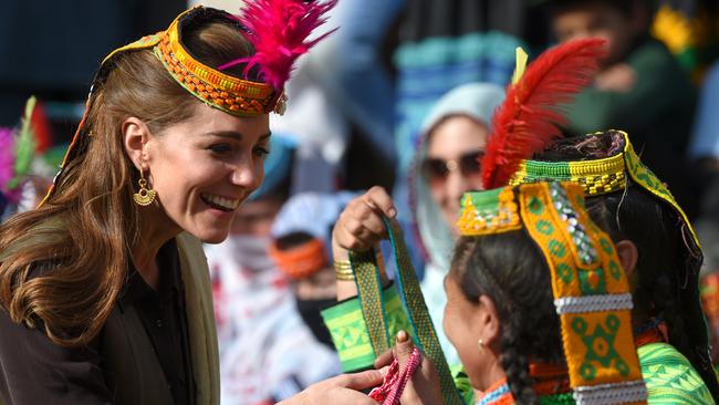 The Duchess of Cambridge receives gifts from a member of the Kalash tribe during her visit to the Bumburate Valley in Pakistan.