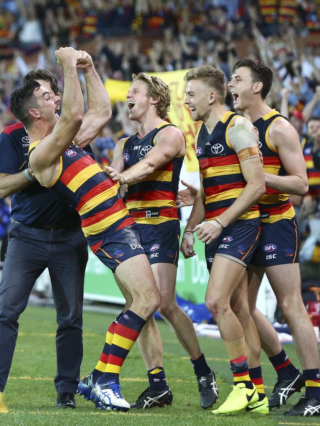 Taylor Walker, Rory Sloane, Hugh Greenwood and Jake Lever celebrate on the siren of last year’s preliminary final win. Picture Sarah Reed.