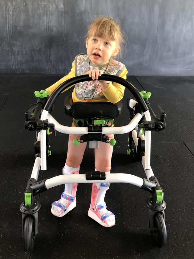 Harper Flynn, 3, is learning to walk with the help of a walker.