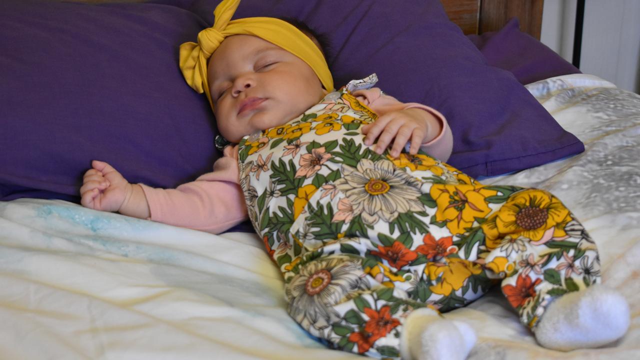 Arlo Lovett, three months, was voted as Mackay's cutest baby for 2020. The "miracle baby" is the daughter of Sammy Lovett, left, and Tenille Tonga, right.