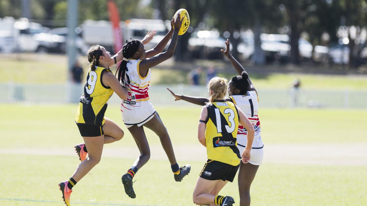 University Cougars player Apajok Deng gets to the ball in front of Summer Bucknell of Toowoomba Tigers in AFL Darling Downs Toowoomba Toyota Cup senior women grand final at Rockville Park, Saturday, September 2, 2023. Picture: Kevin Farmer