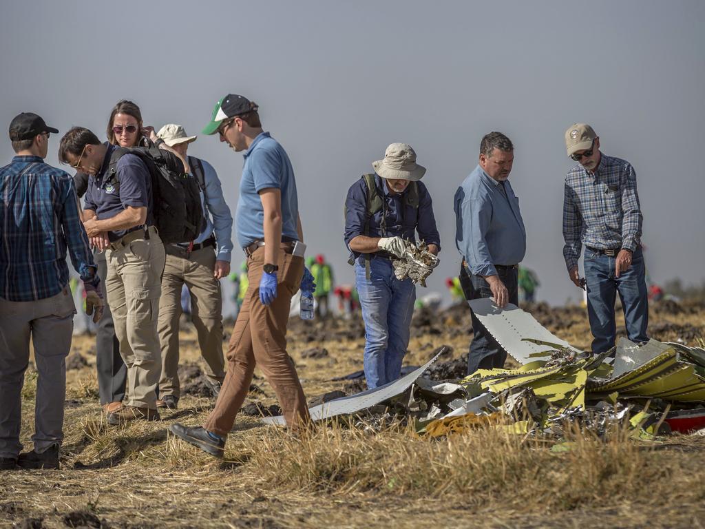 Foreign investigators examine wreckage at the scene where the Ethiopian Airlines Boeing 737 Max 8 crashed shortly after takeoff on Sunday.  Picture:  AP