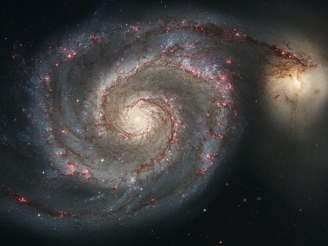 The graceful, winding arms of the majestic spiral galaxy M51 (NGC 5194) appear like a grand spiral staircase sweeping through space. 