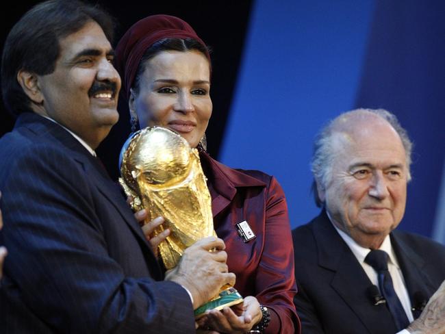The Emir of the state of Qatar, Sheikh Hamad bin Khalifa Al-Thani (L), his wife HH Sheikha Mozah bint Nasser Al-Missned, hold the World Cup Throphy, while FIFA President Sepp Blatter applauds on stage after Qatar was announced as host for the 2022 World Cup during the FIFA 2018 and 2022 World Cup Bid Announcement in Zurich, Switzerland, 02/12/2010.