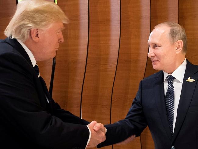 U.S. President Donald Trump and Russia's President Vladimir Putin shake hands during the G20 Summit in Hamburg, Germany in this still image taken from video, July 7, 2017. REUTERS/Steffen Kugler/Courtesy of Bundesregierung/Handout via REUTERS ATTENTION EDITORS - THIS PICTURE WAS PROVIDED BY A THIRD PARTY. NO RESALES. NO ARCHIVE      TPX IMAGES OF THE DAY