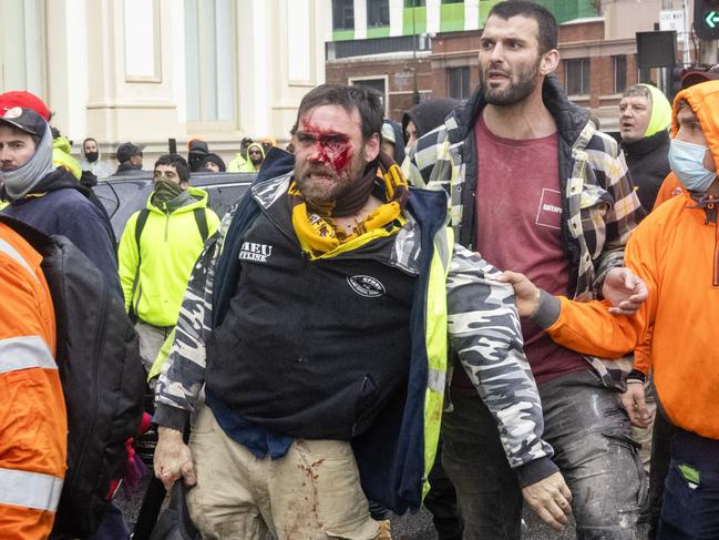 MELBOURNE, AUSTRALIA - NewsWire Photos September 20, 2021:  CFMEU members brawl with each other outside the CFMEU headquarters in Melbourne during a protest about mandatory vaccination in the construction industry.Picture: NCA NewsWire / David Geraghty