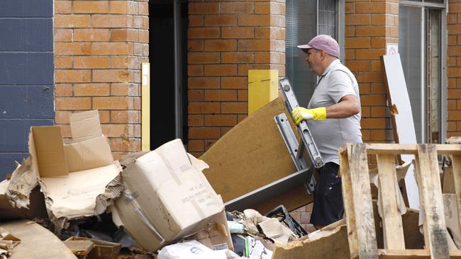 A man cleaning up outside a business in Milton. Picture: Tertius Pickard