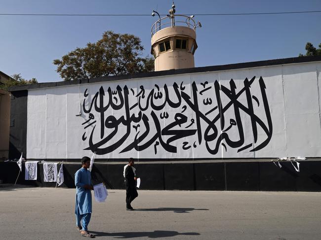 Vendors sell Taliban flags in front of a wall alongside the US embassy in Kabul on September 13, 2021. Picture: AFP