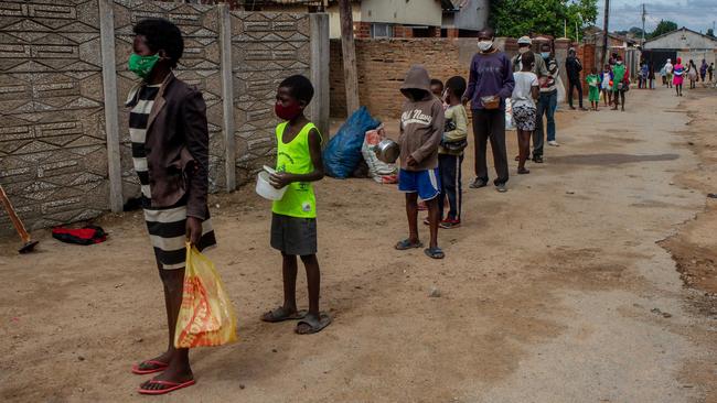 An early morning queue for porridge in Harare, Zimbabwe, on Friday. Picture: Getty Images