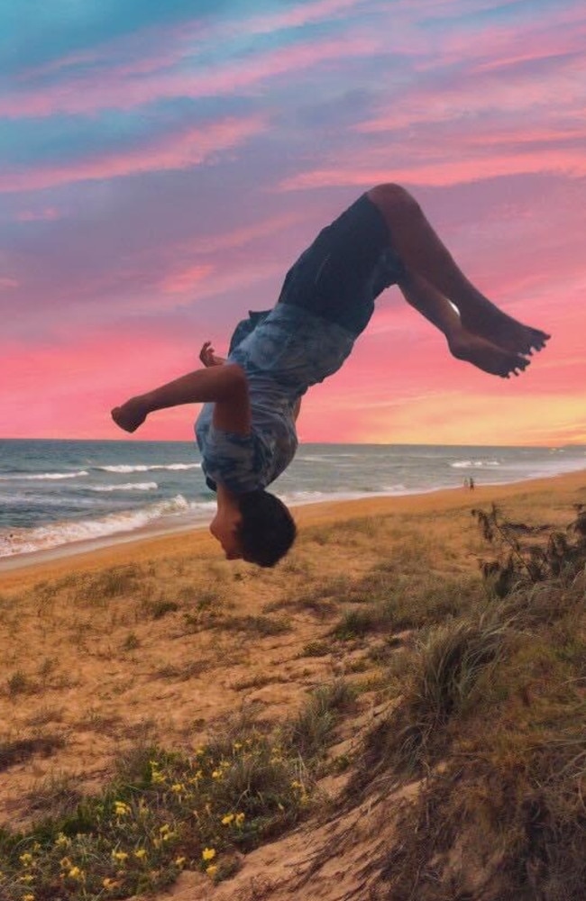 Balin Stewart, a talented gymnast and trampoliner, doing a backflip.