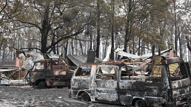 The burnt-out remains of cars and property following bushfires in Old Bar, 350km north of Sydney. Picture: AFP.