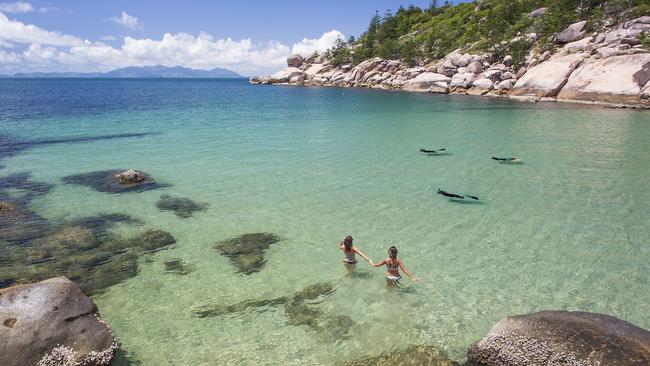 Tourists visit Alma Bay, which is one of the many beautiful beaches on Magnetic Island. The island supports a quarter of the region’s tourism jobs. Picture: Getty Images