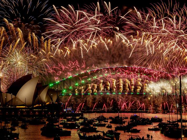 Fireworks explode over the Sydney Harbour Bridge and Sydney Opera House (L) during New Year's Eve celebrations in Sydney. Picture: AFP