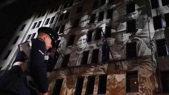 A image showing soldiers is projected on a building during the Anzac Day Dawn service at Martin Place in Sydney last year. Picture: AAP Image/David Moir