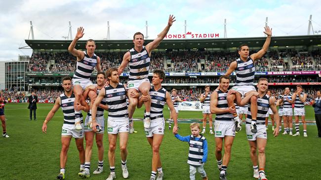 James Kelly, Steve Johnson and Matthew Stokes are chaired off after their last games for the Cats. Picture: Colleen Petch.