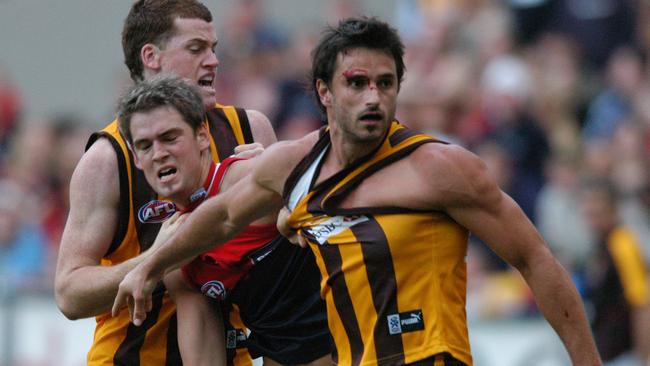 Jarryd Roughead and Ben Dixon in a scuffle with Jared Rivers in 2005.