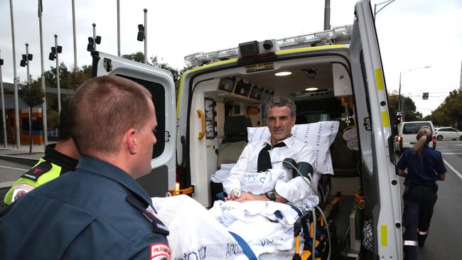 Terry McMaster, the head of financial advice group Dover, leaves the Federal Court with the aid of paramedics after collapsing while being cross examined during the Banking Royal Commission in Melbourne this afternoon. (AAP Image/Stefan Postles)