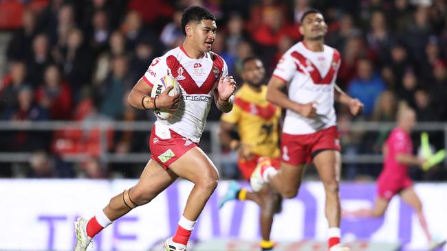 Young gun Isaiya Katoa runs away to score for Tonga. Picture: Charlotte Tattersall/Getty Images