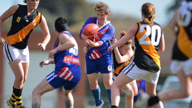 Bowey, with Keysborough in 2012, gets a handpass away under pressure at the 2012 women`s footy finals against South Mornington.