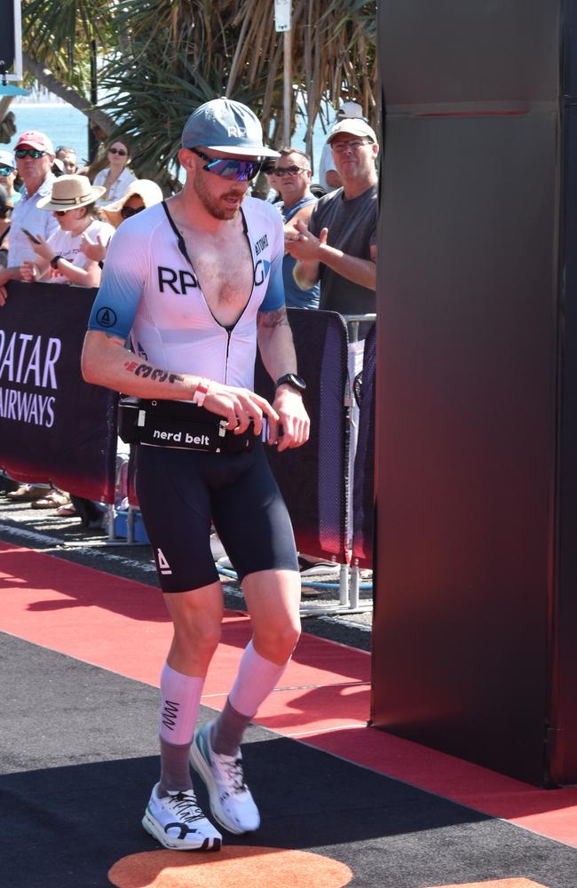 Athletes crossing the finish line at Sunshine Coast Ironman 70.3 2023.