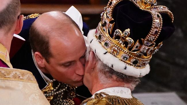 Prince William kisses his father, Britain's King Charles III, during the coronation ceremony. Picture: AFP