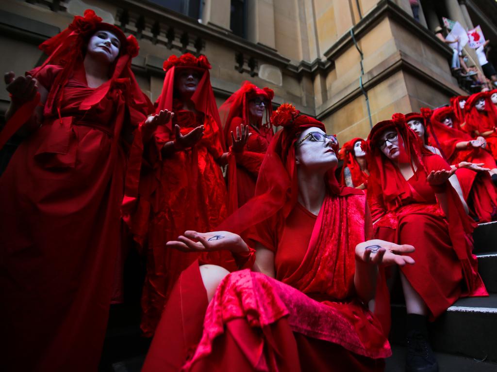 Red Rebels from Extinction Rebellion during a 'Sack ScoMo!' climate change rally in Sydney, Friday, January 10, 2020. (AAP Image/Steven Saphore)