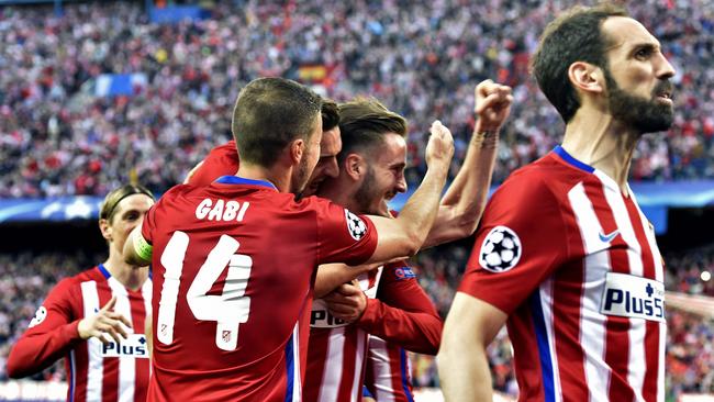 Atletico Madrid's midfielder Saul Niguez (2ndR) celebrates with teammates.