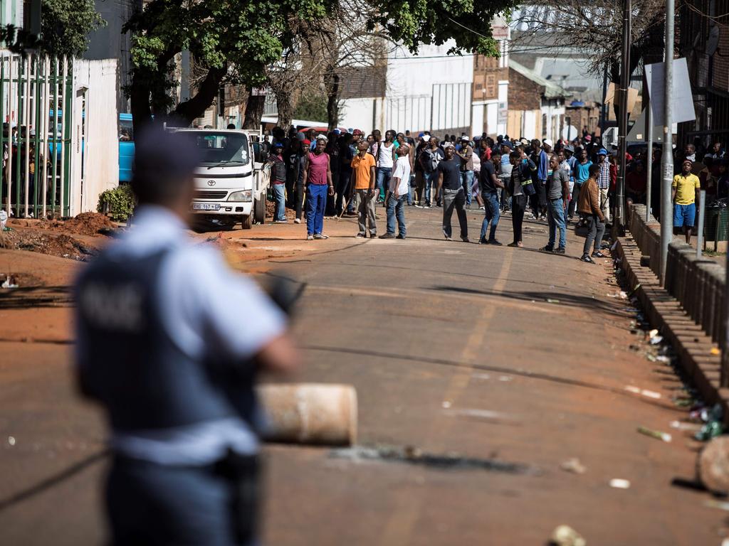 Men carrying sticks, claws and machetes during 2019 rioting in Johannesburg. Picture: Guillem Sartorio/AFP