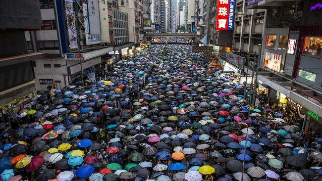 Protester are seen holding up umbrellas while they walk down a street in Hong Kong on August 18, 2019, Tens of Thousands take to the streets of Hong Kong in a rally in Victoria Park -- According to the organizers over 1.7 million people attended the rally , Hong Kong has been rocked by weeks of protest. (Photo by Vernon Yuen/NurPhoto via Getty Images)