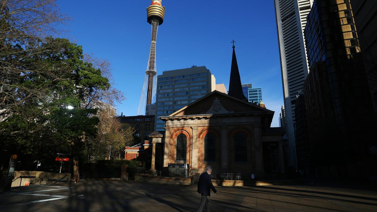 A pedestrian makes their way through the deserted Sydney CBD during lockdown on Monday. Photo: Lisa Maree Williams/Getty Images