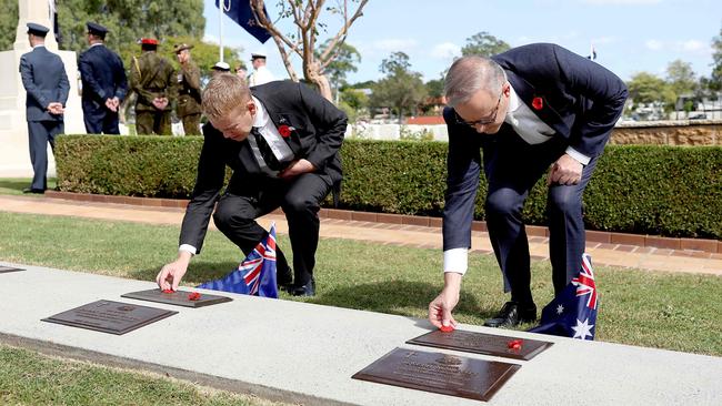 New Zealand Prime Minister Chris Hipkins and Australian Prime Minister Anthony Albanese lay a poppy each on two formerly unmarked New Zealand and Australian WWI veterans’ graves in Brisbane on Sunday. Picture: Pat Hoelscher/AFP