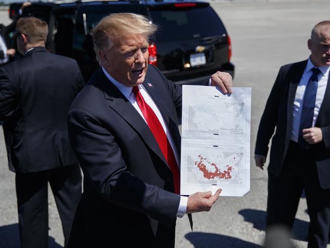 President Donald Trump held two maps of Syria in West Palm Beach, Florida, today. Picture: AP