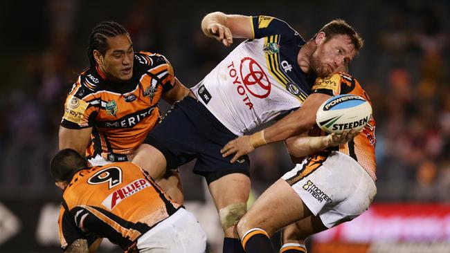 SYDNEY, AUSTRALIA - MAY 23: Gavin Cooper of the Cowboys offloads the ball in a tackle during the round 11 NRL match between the Wests Tigers and the North Queensland Cowboys at Campbelltown Sports Stadium on May 23, 2015 in Sydney, Australia. (Photo by Matt King/Getty Images)