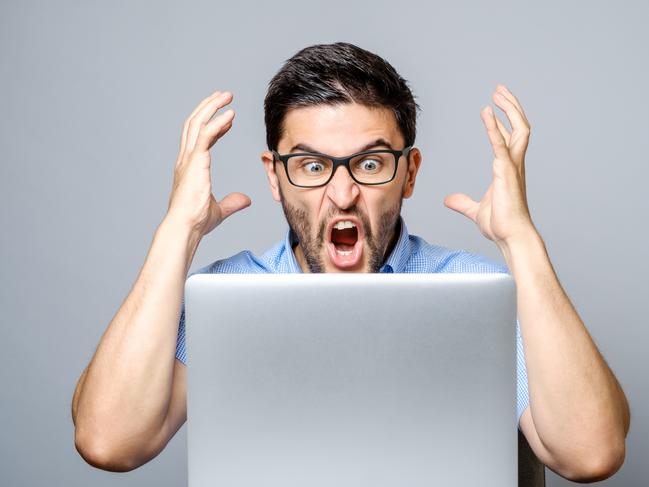 An angry man using his computer. Picture: iStock.