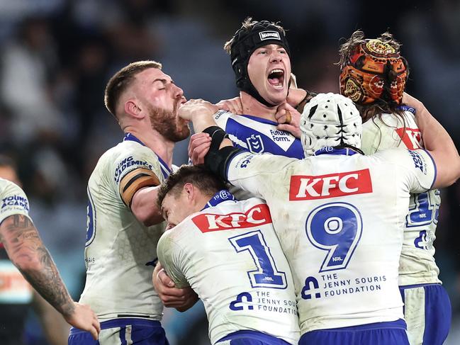 SYDNEY, AUSTRALIA - JUNE 28:  Matt Burton of the Bulldogs celebrates with team mates after kicking a golden point field goal in extra time to win the round 17 NRL match between Canterbury Bulldogs and Cronulla Sharks at Accor Stadium on June 28, 2024, in Sydney, Australia. (Photo by Cameron Spencer/Getty Images)