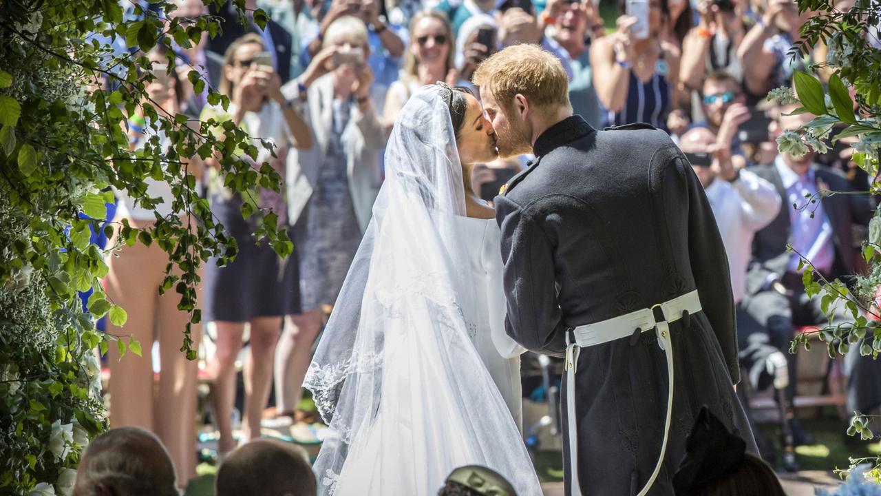 Prince Harry and Meghan Markle kiss on the steps of St George's Chapel. Picture: Danny Lawson - WPA Pool/Getty Images