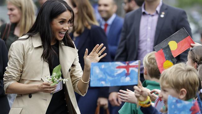 Meghan waves at school kids. Picture: AP