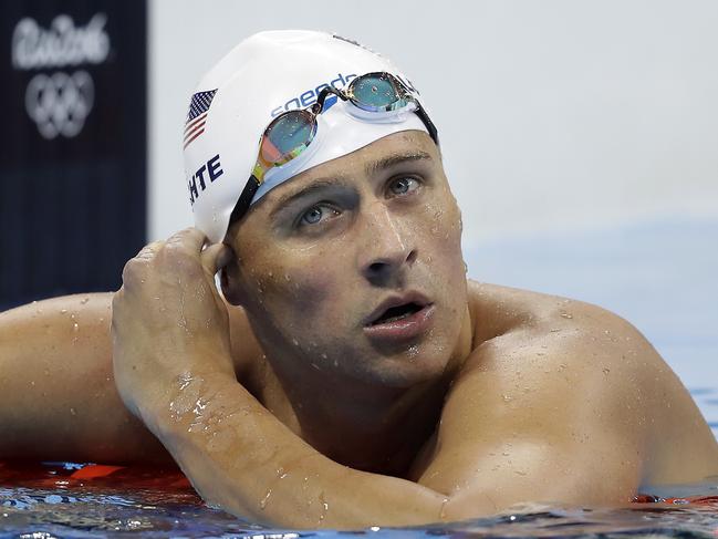 FILE - In this Tuesday, Aug. 9, 2016, file photo, United States' Ryan Lochte checks his time in a men's 4x200-meter freestyle heat during the swimming competitions at the 2016 Summer Olympics, in Rio de Janeiro, Brazil. Lochte and three other American swimmers were robbed at gunpoint early Sunday, Aug. 14, by thieves posing as police officers who stopped their taxi and took their money and belongings, the U.S. Olympic Committee said. (AP Photo/Michael Sohn, File)