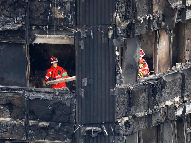 Emergency services work on the middle floors of the charred remnains of the Grenfell Tower block. Picture: AFP