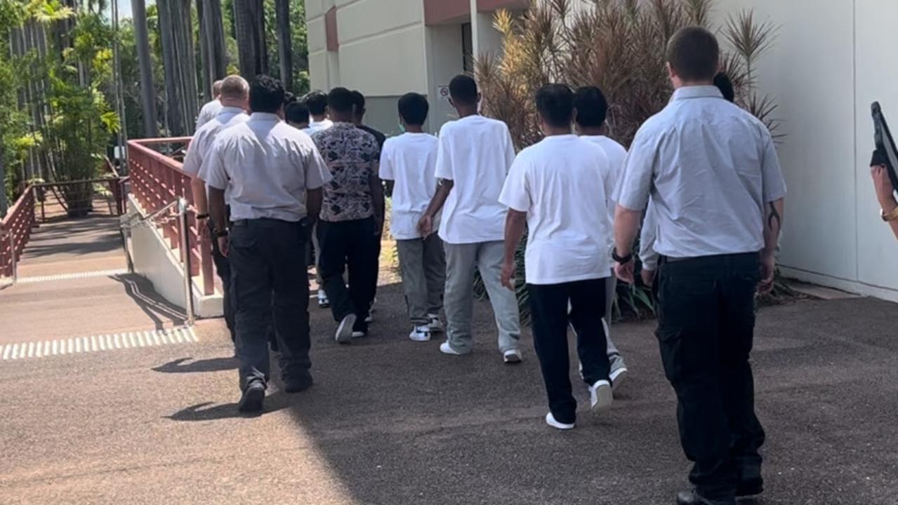 The crew being led away from Darwin Local Court. Picture: Harry Brill.