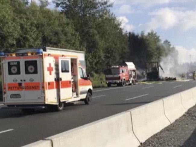 Smoke rises from a coach after a crash on the motorway AP near Muenchberg. Picture: AP