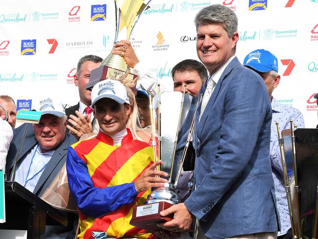 Jockey Corey Brown (left) poses for a photograph with Queensland Racing Minister Sterling Hinchcliff after Pierata won race 7, the Magic Millions Three-Years-Old Guineas, during the Gold Coast Magic Millions at Aquis Park, Gold Coast Turf Club, Queensland, Saturday, January 13, 2018. (AAP Image/Albert Perez) NO ARCHIVING, EDITORIAL USE ONLY